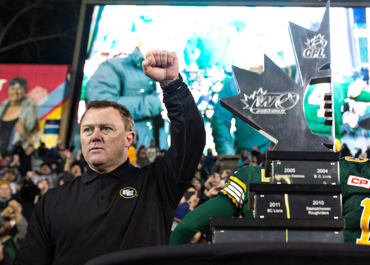 Edmonton Eskimos head coach Chris Jones stands with the CFL West trophy after defeating the Calgary Stampeders during the CFL West Division final in Edmonton, Alta., on Sunday November 22, 2015. 