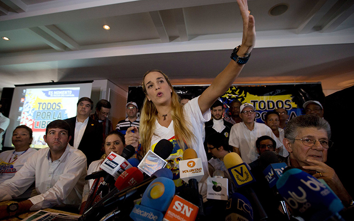 Lilian Tintori, wife of jailed opposition leader Leopoldo Lopez, waves before the start of a news conference in Caracas, Venezuela, Thursday, Nov. 26, 2015. An opposition leader was shot to death Wednesday while campaigning for next week's congressional elections in Venezuela. 