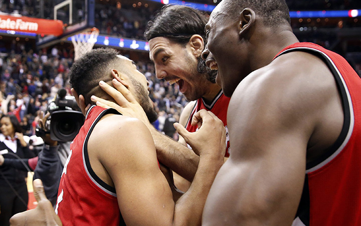 Toronto Raptors guard Cory Joseph, left, celebrates with forward Luis Scola and center Bismack Biyombo after the Raptors beat the Wizards on Saturday, Nov. 28, 2015, in Washington.
