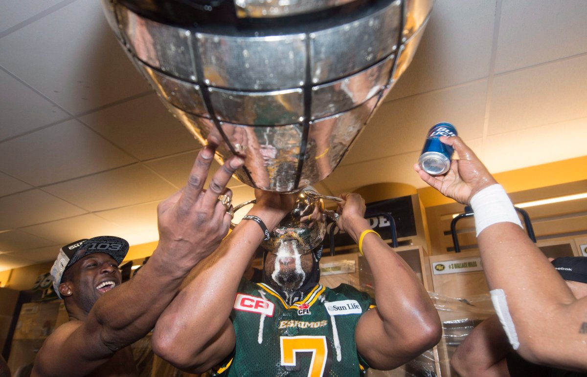 Edmonton Eskimos' Kenny Stafford drinks from the Grey Cup following his teams win over the Ottawa Redblacks at the 103rd Grey Cup in Winnipeg, Man., Sunday, Nov. 29, 2015. 