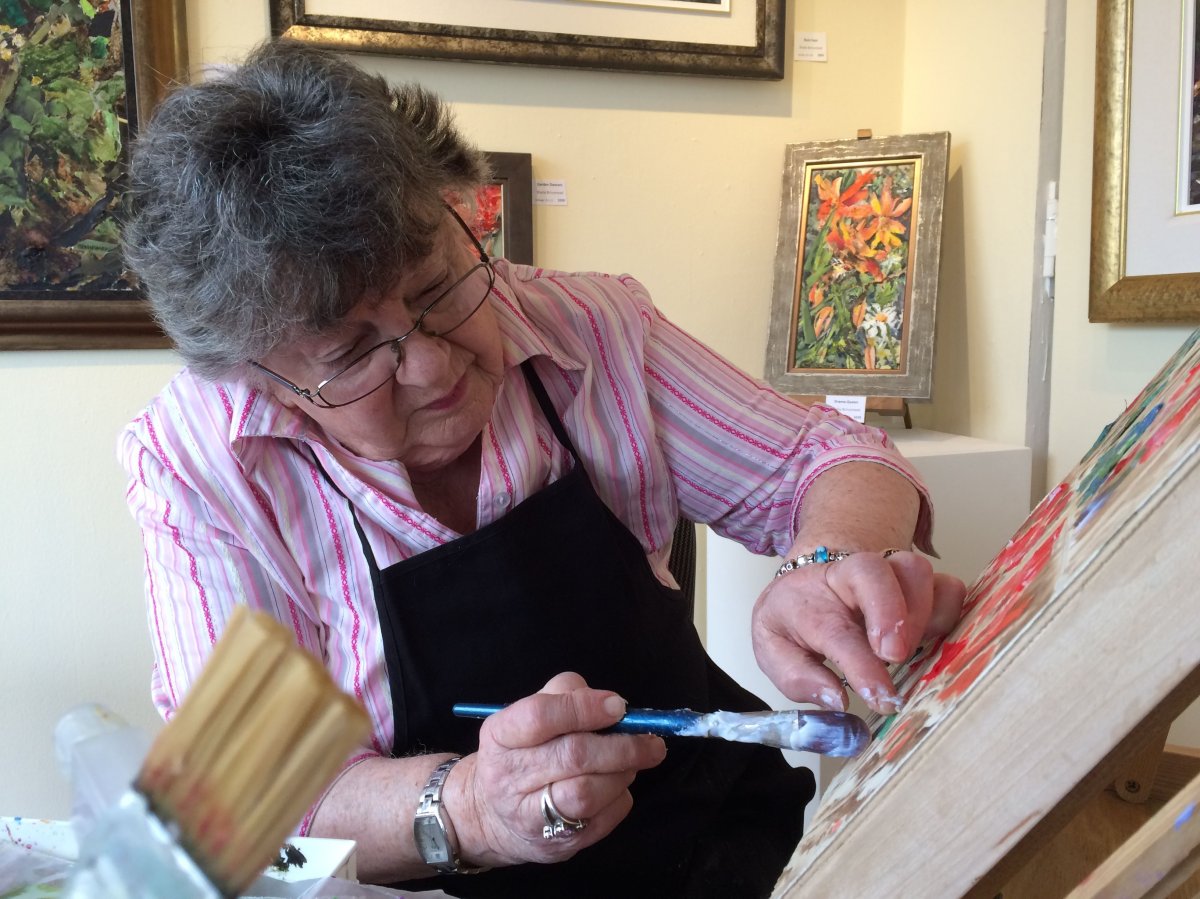 Sheila Brinsmead puts the finishing touches on her first art exhibit.