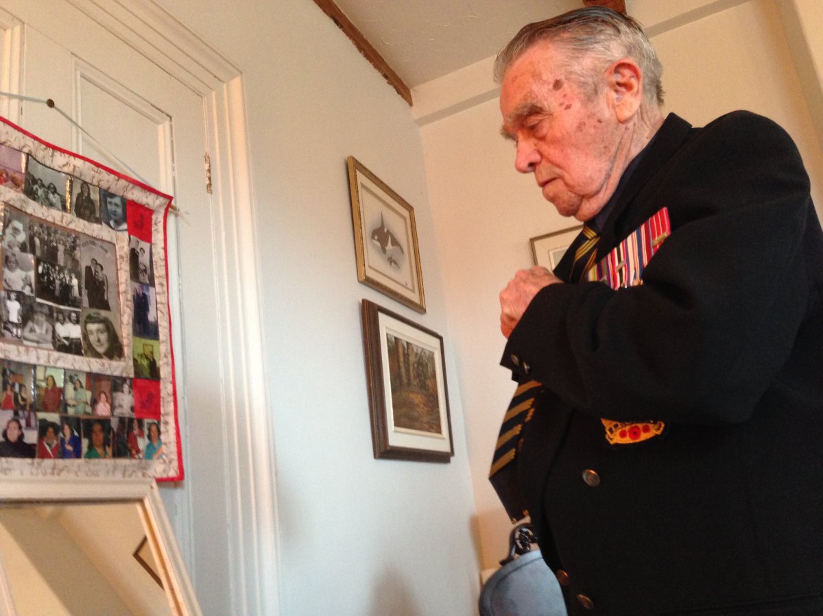 Veteran Rowland Marshall puts his suit and medals on ahead of a Remembrance Day service.