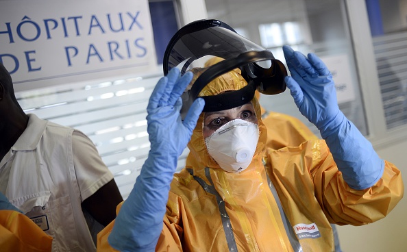 Medical staff wears protective clothes during an exercise to prepare the service in case of an Ebola virus outbreak on October 24, 2014 at the SAMU headquarters in Paris.  