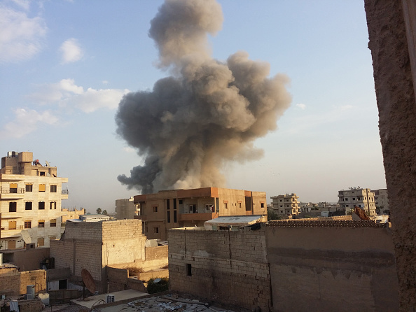 Smoke rises after air strikes by Syrian army warplanes on the ISIL-held northern city of Raqqa, Syria on November 25, 2014.