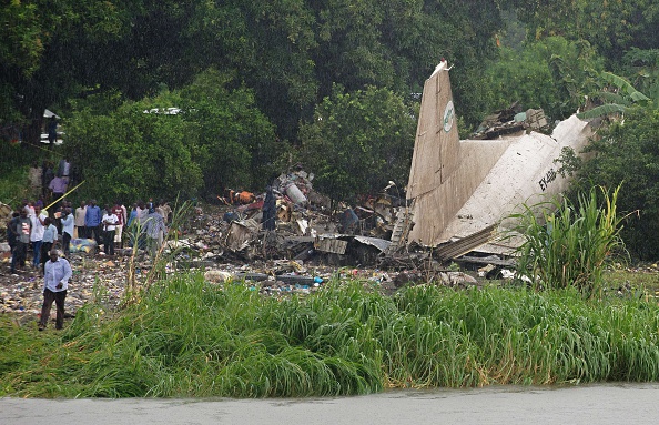 People gather at the site where a cargo plane crashed into a small farming community on a small island in the White Nile river, close to Juba airport in the Hai Gabat residential area, on November 4, 2015. At least 25 people were killed on November 4 when a plane crash-landed shortly after taking off from South Sudan's capital Juba, an AFP reporter said. 