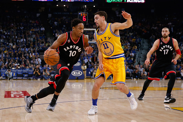 DeMar DeRozan #10 of the Toronto Raptors drives on Klay Thompson #11 of the Golden State Warriors at ORACLE Arena on November 17, 2015 in Oakland, California.