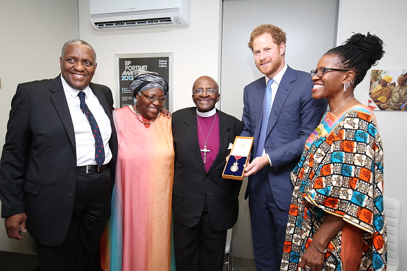 Prince Harry presents the Archbishop Emeritus Desmond Tutu with the Order of the Companion of Honour at the offices of The Desmond & Leah Tutu Legacy Foundation on the first day of his visit to South Africa on November 30, 2015 in Cape Town, South Africa. (Chris Radburn - WPA Pool /Getty Images).