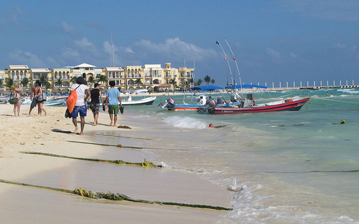 People walk on the beach in Playa del Carmen, Mexico.