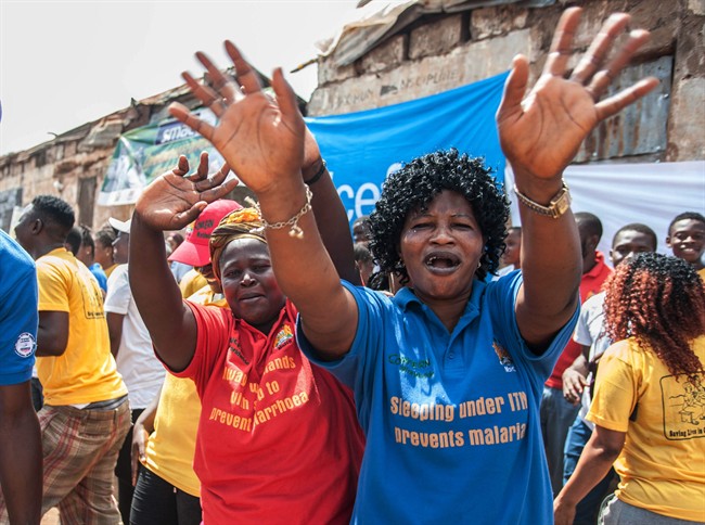 Women celebrate as their country is declared Ebola free in the city of Freetown Sierra Leone, Saturday, Nov. 7, 2015. 