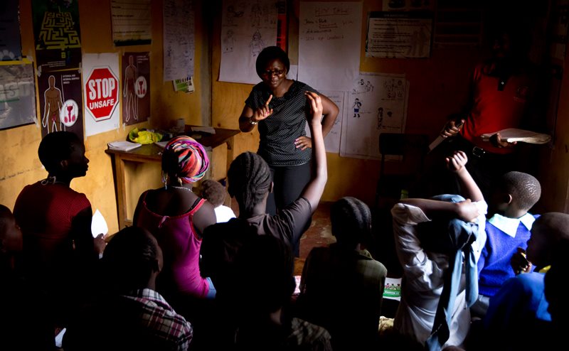 In this photo taken Monday, Feb. 16, 2015, HIV-counseling and prevention course facilitators conduct an HIV prevention session entitled "Healthy Choices for a Better Future" to a group comprised of children, adolescents and adults who are either HIV-positive or at high risk of catching HIV due to their circumstances.