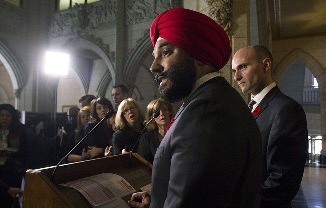 Minister of Families, Children and Social Development Jean-Yves Duclos looks on as Innovation, Science and Economic Development Minister Navdeep Bains responds to a question in the Foyer of the House of Commons on Parilament Hill in Ottawa Thursday, November 5, 2015. THE CANADIAN PRESS/Adrian Wyld.