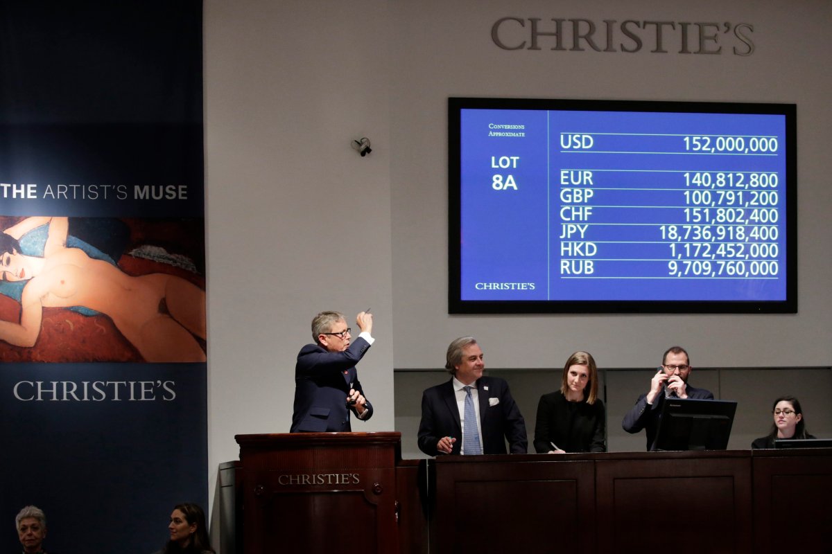 Auctioneer Jussi Pylkkanen bangs the final hammer as he sells Amedeo Modigliani's 'Nu couche' during the 'Artist's Muse: A Curated Evening Sale' at Christie's Auction House.