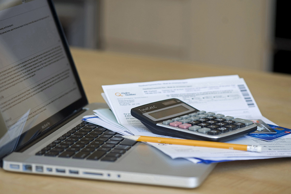 FILE: A laptop with a pile of utility bills shown on Saturday, April 30, 2011.