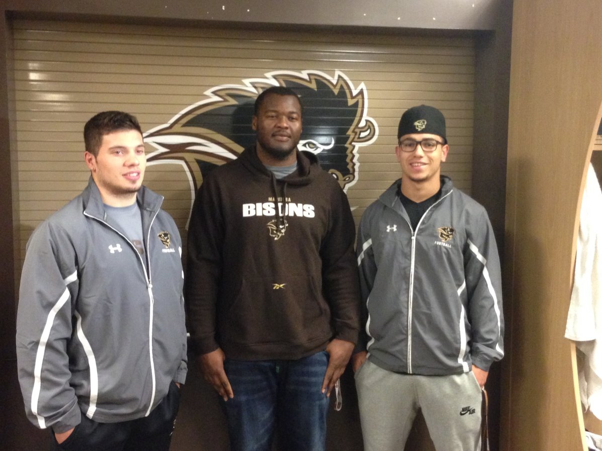 Manitoba Bisons players DJ Lalama, David Onyemata and Jamel Lyles pose after getting named major award winners in Canada West.