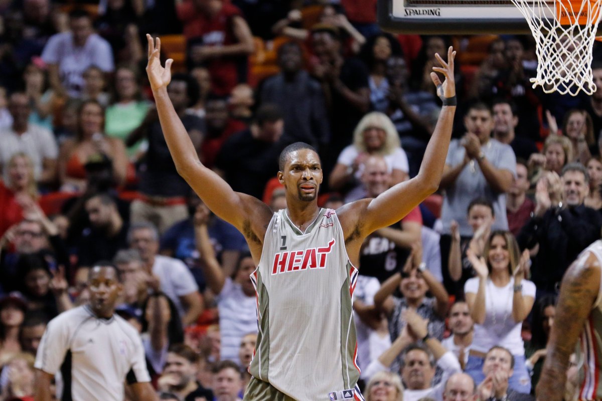 Miami Heat forward Chris Bosh (1) reacts to applause after scoring a 3-point shot against the Toronto Raptors in the second half of an NBA basketball game, Sunday, Nov. 8 2015, in Miami. 