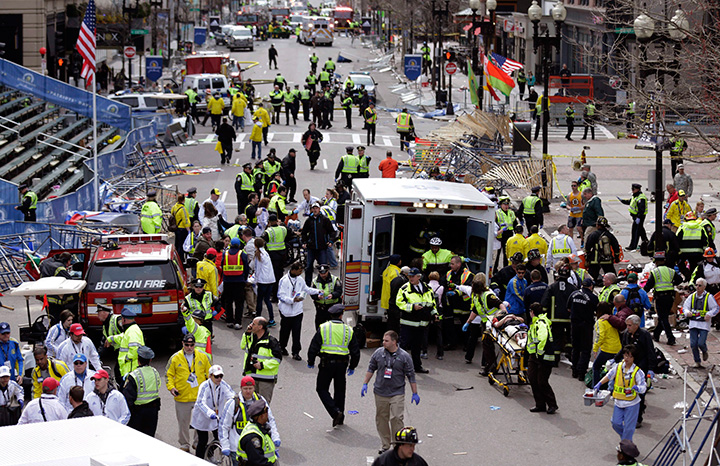 In this April 15, 2013, file photo, medical workers aid injured people following an explosion at the finish line of the 2013 Boston Marathon. 