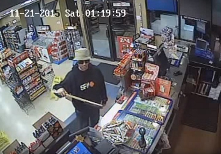 Thunder Bay police say the man shown above robbed two convenience stores with an automotive snow scraper and brush.