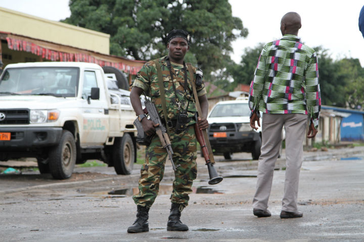 A Burundian soldier with his gun and rocket launcher guard a deserted street in Bujumbura, Burundi, Sunday, Nov. 8.