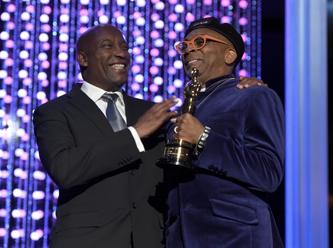 John Singleton, left, and Spike Lee, honorary Oscar recipient, pose onstage at the Governors Awards at the Dolby Ballroom on Saturday, Nov. 14, 2015, in Los Angeles. 