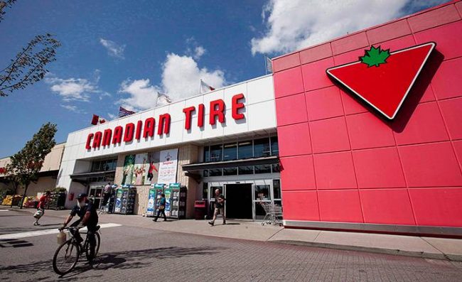A man cycles by a Canadian Tire store in North Vancouver on May 10, 2012.