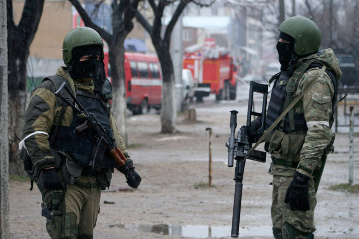 In this Jan. 20, 2014, file photo Russian special force soldiers wear masks during an anti-terrorist operation in Makhachkala, regional capital of Dagestan, Russia.