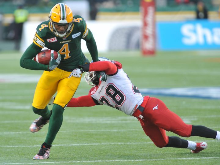 Edmonton Eskimos player #4  (SB) Adarius Bowman tries to get away from Calgary Stampeders player #28 (DB) Brandon Smith during the 2nd quarter of CFL Western Final playoff game action between the Edmonton Eskimo's and the Calgary Stampeders at Commonwealth stadium in Edmonton on Sunday, November 22/2015 .