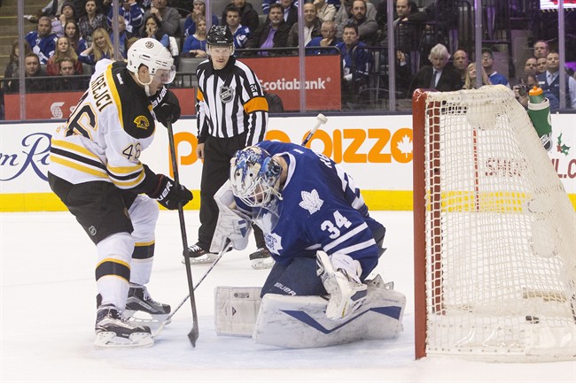 Boston Bruins David Krejci (left) scores the Bruins' winning shoot out goal on Toronto Maple Leafs James Reimer in NHL hockey action in Toronto on Monday, November 23, 2015.