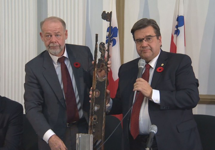 Montreal Mayor Denis Coderre compares an old and new sewage pipe, Tuesday, November 10, 2015.