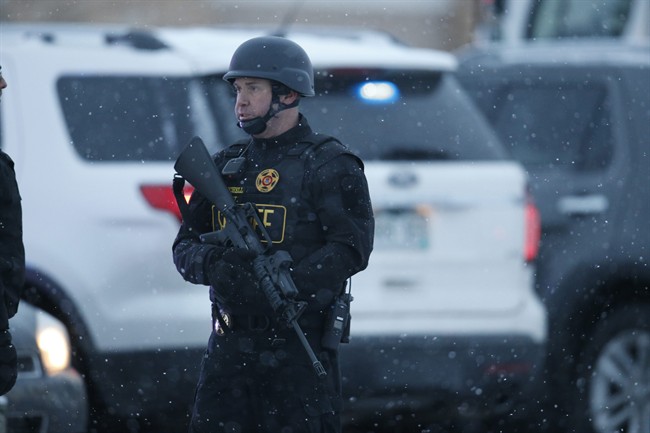 Police stand guard near a Planned Parenthood clinic Friday, Nov. 27, 2015, in Colorado Springs, Colo. A gunman opened fire at the clinic on Friday, authorities said, wounding multiple people.