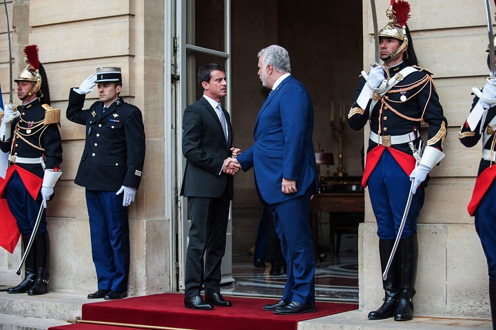 In this file photo French Prime Minister Manuel Valls, left, shakes hands with Quebec Premier Philippe Couillard in Paris, France in March 2015. Couillard is in Paris for international climate change conference
that will formally begin Monday.
the AP Photo/).