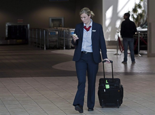 An Air Canada flight attendant walks through the terminal at the Halifax airport on Sept. 20, 2011. 