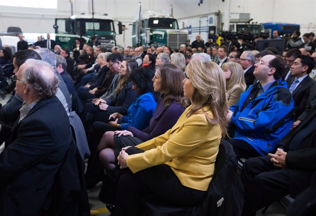 Dianne Watts, centre, who served as the mayor of Surrey from 2005-2014, listens as then-prime minister Stephen Harper speaks during an announcement about the apprentice loan program at the British Columbia Institute of Technology Annacis Island Campus in Delta, B.C., on January 8, 2015.