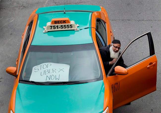 A taxi driver protests Uber in Toronto on June 1, 2015. 