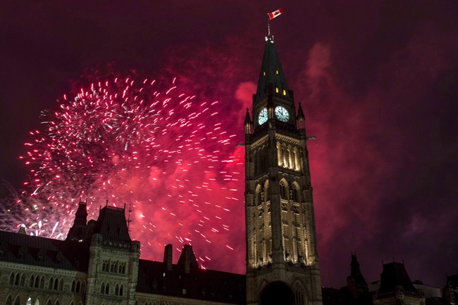 Fireworks explode behind the Peace Tower on Parliament Hill.