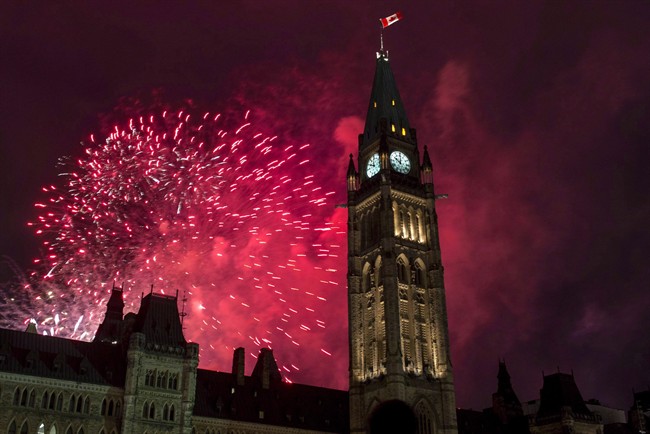 Fireworks explode behind the Peace Tower on Parliament Hill.