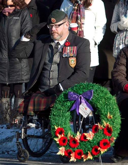 Veteran Paul Franklin, who lost both his legs in a suicide bombing in Kandahar, is shown saluting during the First Battalion Princess Patricia's Canadian Light Infantry Remembrance Day ceremony in Edmonton, Alberta, on Monday, November 11, 2013.