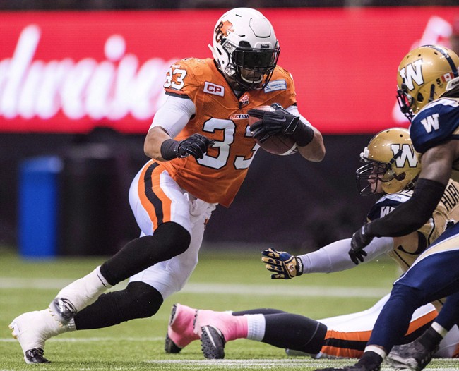 Andrew Harris runs the ball against the Winnipeg Blue Bombers during the first half of a CFL football game in Vancouver, B.C., on Saturday, October 10, 2015.