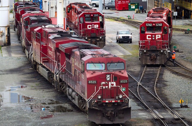 A Canadian Pacific Rail maintenance worker climbs onto a locomotive at the company's Port Coquitlam yard east of Vancouver, B.C., on Wednesday May 23, 2012. Canadian Pacific Railway's dream of creating North America's largest railroad faces a long and uncertain future following Norfolk Southern's cool initial response to the Calgary company's US$28-billion takeover proposal.