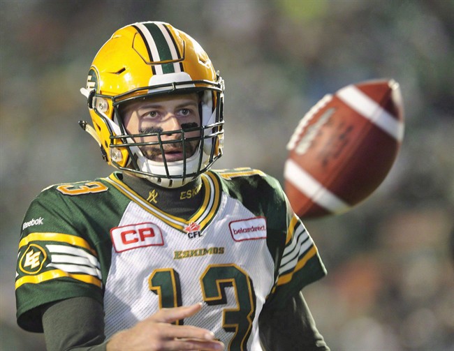 Edmonton Eskimos quarterback Mike Reilly flips the ball to an official after running the ball for an extra point against the Saskatchewan Roughriders in second half CFL action in Regina on October 24, 2015. Reilly and the Edmonton Eskimos have a glorious opportunity to prove this is their time. 