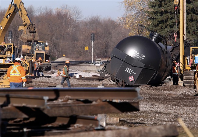 Workers tend to the scene of a train derailment in Watertown, Wis. Monday, Nov. 9, 2015.