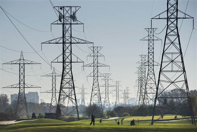 Hydro towers are seen over a golf course in Toronto. 