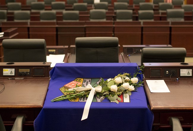 A flag and flowers are draped over the desk of MLA Manmeet Bhullar at the Alberta Legislature chambers in Edmonton Alta, on Tuesday November 24, 2015. Bhullar, 35, was killed in a car accident on Monday afternoon while driving from Calgary to Edmonton.