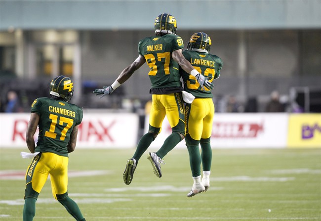 Edmonton Eskimos' Shamawd Chambers (17), Derel Walker (87) and Kendial Lawrence (32) celebrate a touchdown against the Montreal Alouettes during second half action in Edmonton, Alta., on Sunday November 1, 2015.