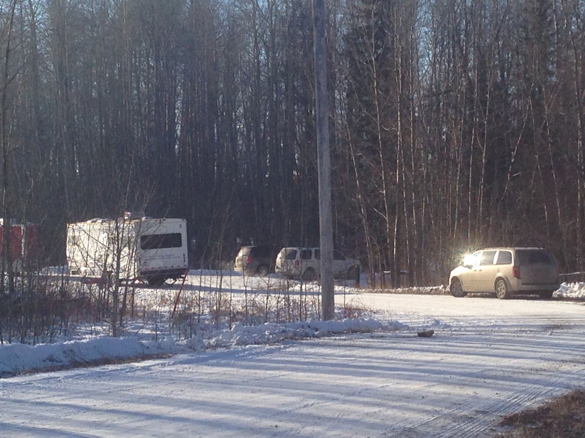 RCMP investigate a homicide scene east of Edson, Alta., where a man, woman and teenage girl were found dead in a rural home on Sunday. November 30, 2015.