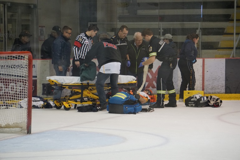 Paramedics working on Braden Pettinger on-ice.