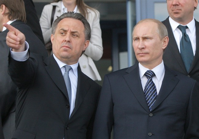 In this 2011 file photo then Russian Prime Minister Vladimir Putin, right, is flanked by Sports Minister Vitaly Mutko, left, as they visit a sports complex that is under construction for the 2014 Winter Olympic Games, in Krasnodar, southern Russia.