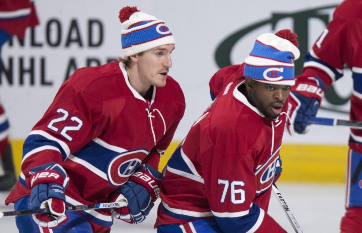 Montreal Canadiens' P.K. Subban, right, Dale Weise and other team members wear a toque to promote the 2016 NHL Winter Classic during the warm-up prior to facing the Boston Bruins, in Montreal, on Saturday, Nov. 7, 2015.