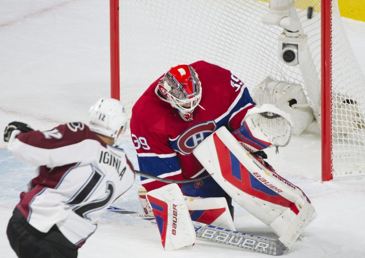 Montreal Canadiens goaltender Mike Condon makes a save against Colorado Avalanche's Jerome Iginla during first period NHL hockey action in Montreal, Saturday, November 14, 2015.