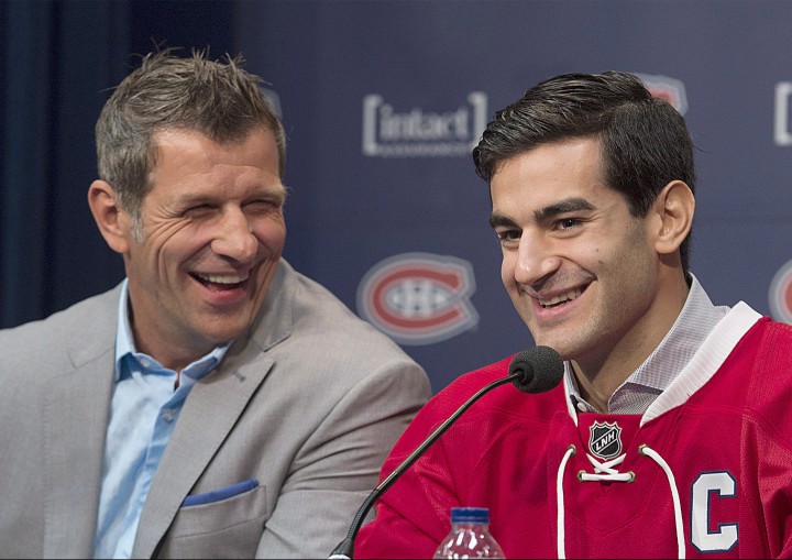 Montreal Canadiens' Max Pacioretty, right, and Canadiens General Manager Marc Bergevin laugh during a news conference in Brossard, Que., on Friday, Sept. 18, 2015.