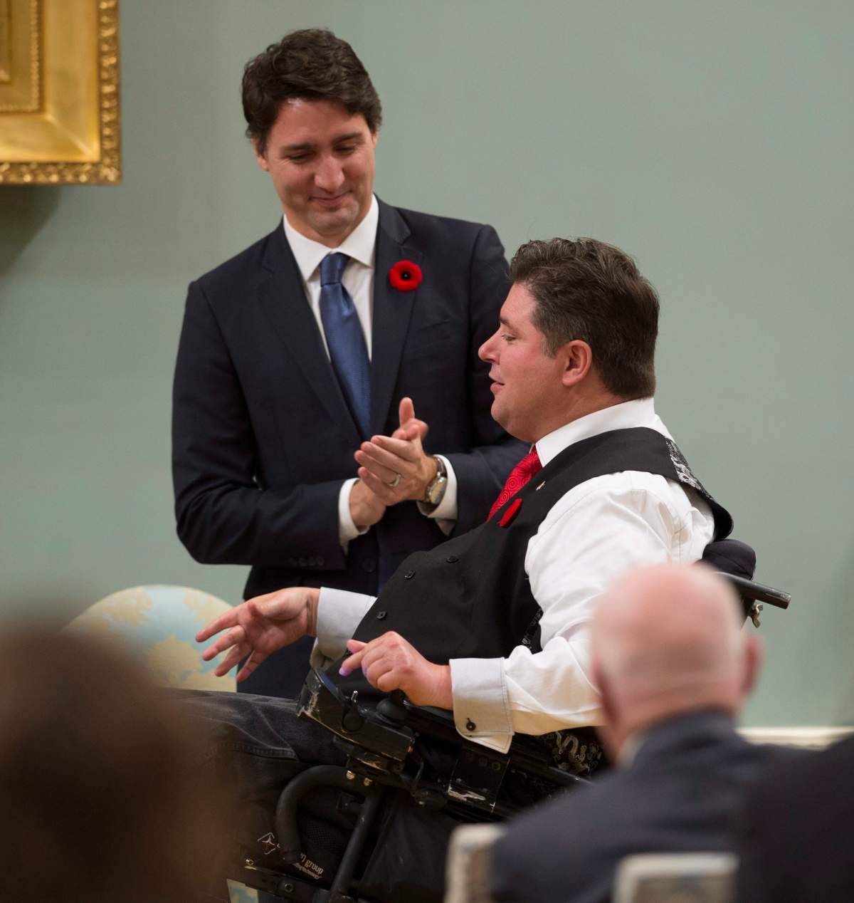 Prime Minister Justin Trudeau applauds after Kent Hehr was appointed Minister of Veterans Affairs and Associate Minister of National Defence Minister during a swearing in ceremony Wednesday Nov.4, 2015 in Ottawa.